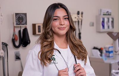 Lizzie Ochoa in white medical coat.
