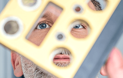 Tyrone Rooney looking through object.