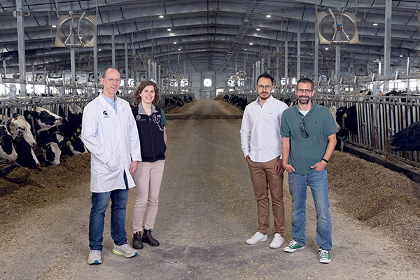 image of Sean Crosson, Ana Moreira, Miguel Chirivi, and Andrew Olive in dairy facility.
