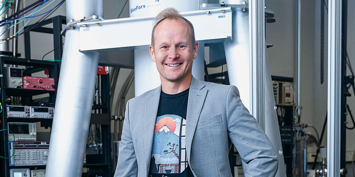 Johannes Pollanen standing in a lab smiling.