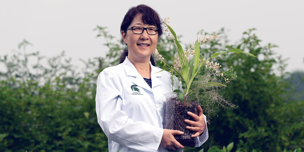 Sue Rhee holding a plant